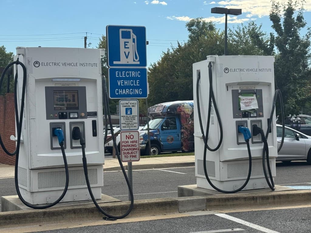 Vehicles plugged in and charging at the EV Charging Hub parking area